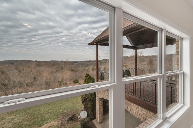 sunroom / solarium with a forest view