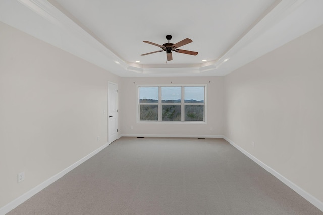 carpeted empty room with ceiling fan, recessed lighting, visible vents, baseboards, and a tray ceiling