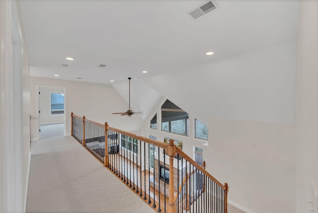 hallway featuring recessed lighting, visible vents, light carpet, an upstairs landing, and baseboards