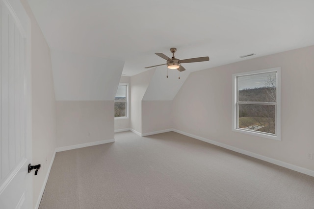 bonus room with light carpet, ceiling fan, baseboards, and lofted ceiling