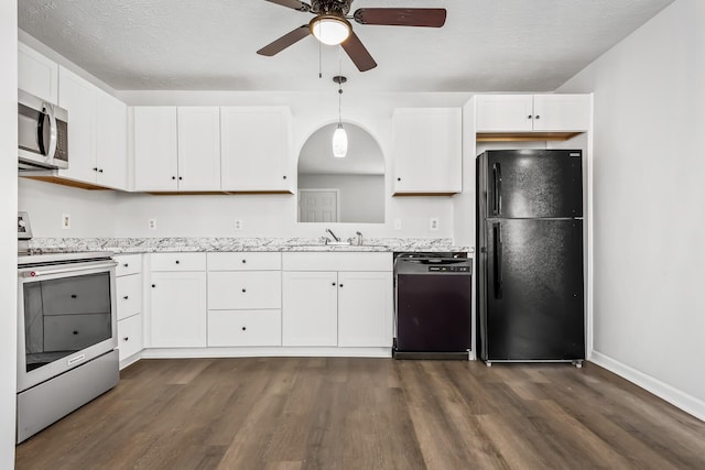 kitchen featuring black appliances, hanging light fixtures, a sink, and white cabinetry