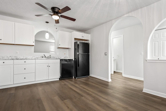 kitchen with black appliances, dark wood-style floors, white cabinetry, and arched walkways