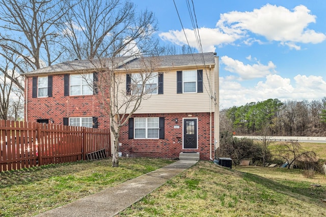 view of front of home featuring entry steps, fence, cooling unit, a front lawn, and brick siding