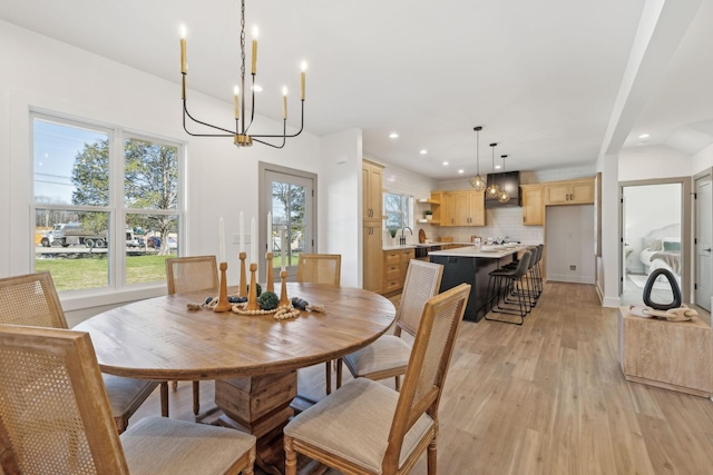 dining room with a chandelier, recessed lighting, and light wood-style flooring