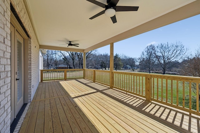 deck with a yard and a ceiling fan