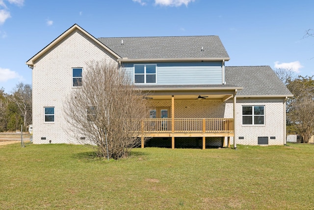 rear view of house with crawl space, ceiling fan, a shingled roof, and a lawn