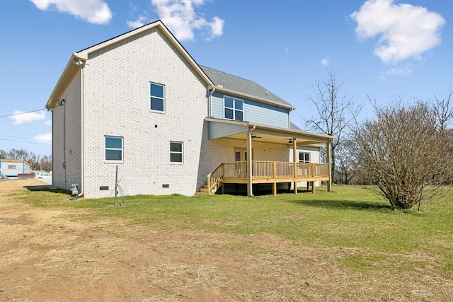 rear view of property featuring crawl space, a yard, a deck, and brick siding