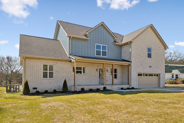 view of front of house with brick siding, covered porch, an attached garage, board and batten siding, and a front lawn