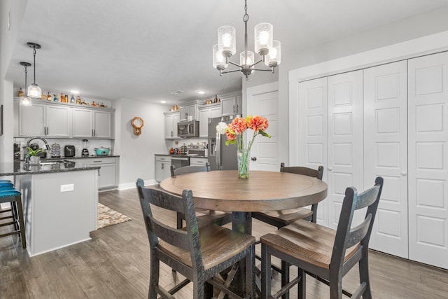 dining room with baseboards and dark wood-type flooring