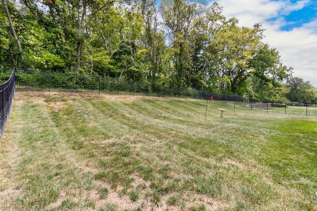 view of yard featuring fence and a rural view