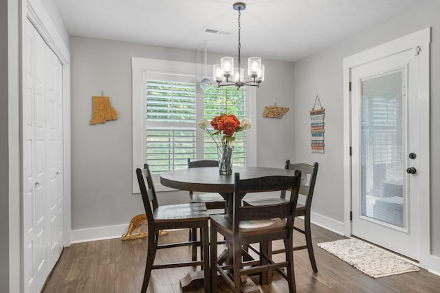 dining room with visible vents, baseboards, a chandelier, and dark wood-style flooring