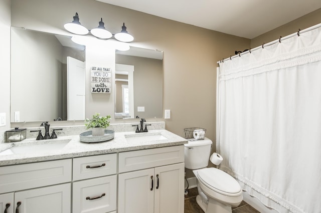 full bathroom with double vanity, curtained shower, toilet, and a sink