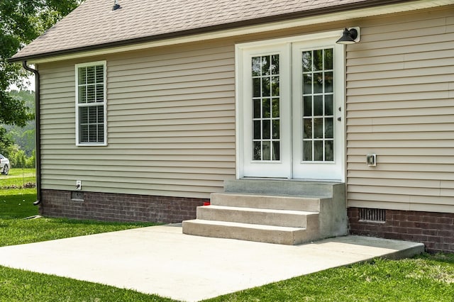 property entrance with crawl space, french doors, and roof with shingles