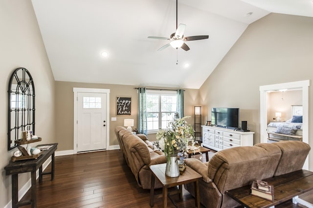 living room with ceiling fan, high vaulted ceiling, dark wood finished floors, and baseboards