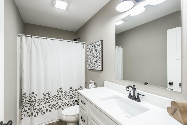 bathroom featuring toilet, visible vents, and vanity