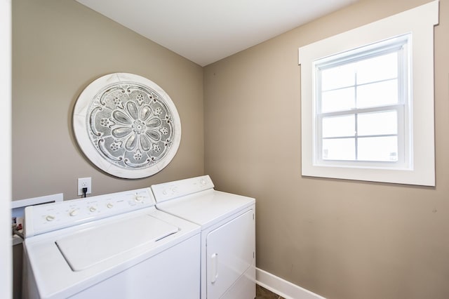 clothes washing area featuring laundry area, independent washer and dryer, and baseboards