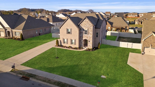 french country home with a residential view, fence, and a front lawn