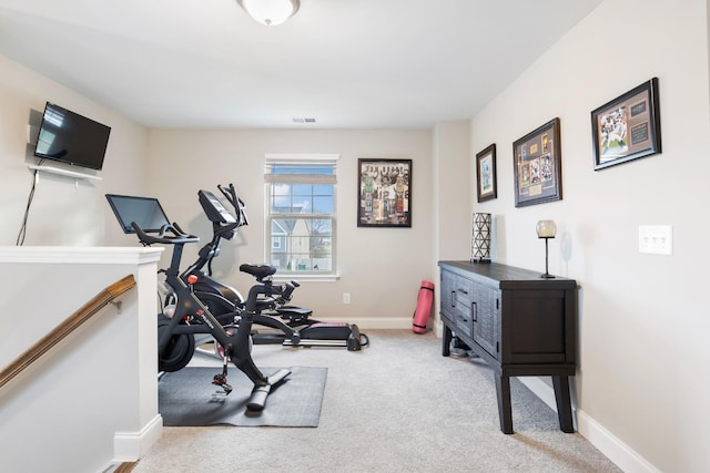 exercise area with light carpet, visible vents, and baseboards