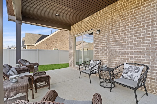 view of patio with fence and outdoor lounge area