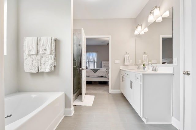 ensuite bathroom featuring a garden tub, a sink, baseboards, double vanity, and ensuite bath