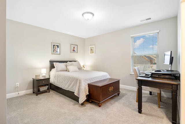 bedroom featuring baseboards, visible vents, and light colored carpet