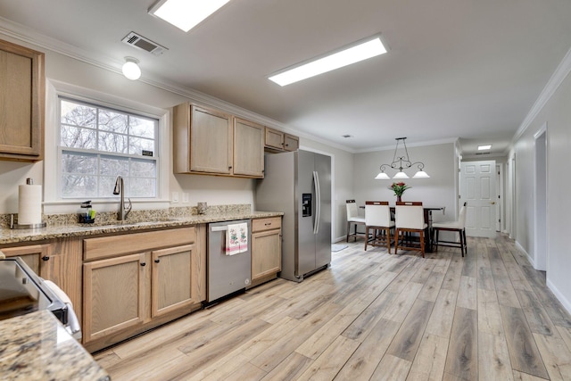 kitchen featuring stainless steel appliances, visible vents, light wood finished floors, and light brown cabinets