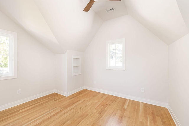 additional living space featuring light wood-style flooring, baseboards, and a wealth of natural light