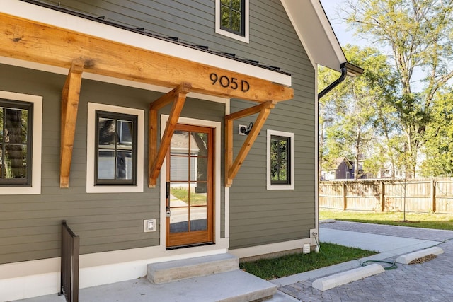 doorway to property with fence