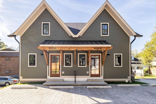 view of front of house with covered porch, metal roof, and a standing seam roof