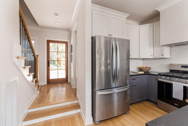 kitchen with visible vents, appliances with stainless steel finishes, gray cabinetry, light wood-style floors, and white cabinetry