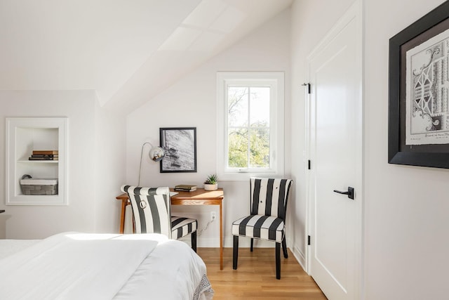 bedroom featuring light wood-type flooring and lofted ceiling