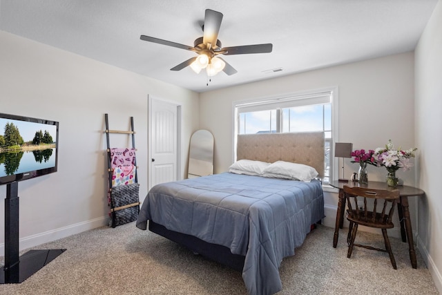bedroom with light colored carpet, baseboards, and ceiling fan
