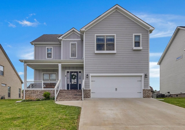 view of front facade featuring board and batten siding, a front yard, covered porch, and an attached garage