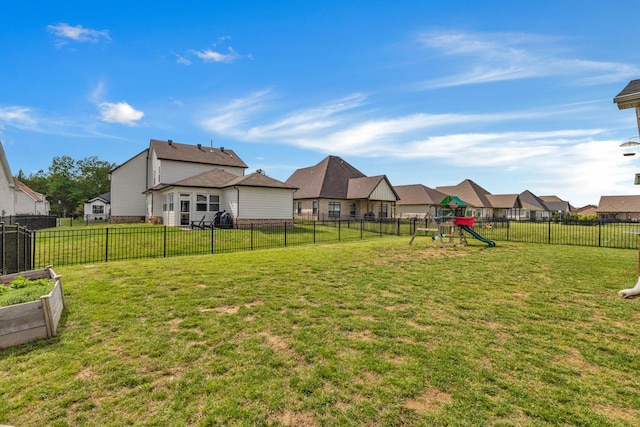 view of yard with a playground, a residential view, and a vegetable garden
