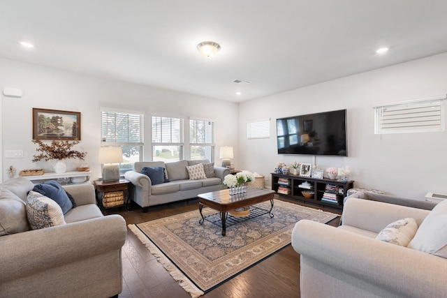 living room featuring dark wood-type flooring, recessed lighting, and visible vents