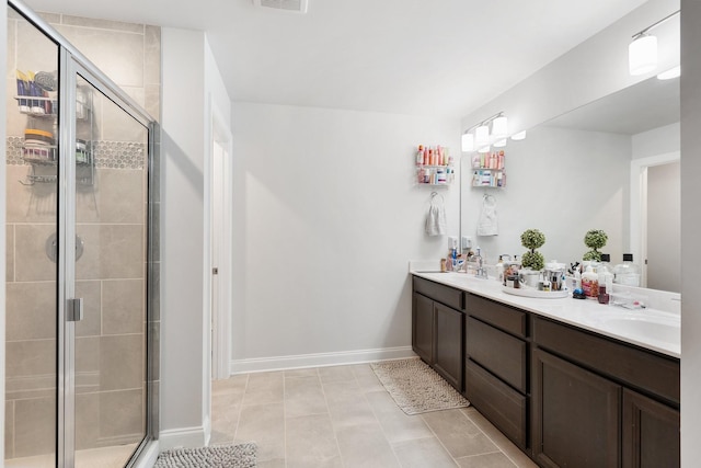 full bath with baseboards, double vanity, a sink, and a shower stall