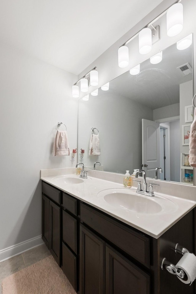 full bath with double vanity, visible vents, a sink, and tile patterned floors