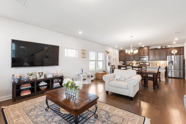 living room with dark wood-style floors, baseboards, a chandelier, and recessed lighting