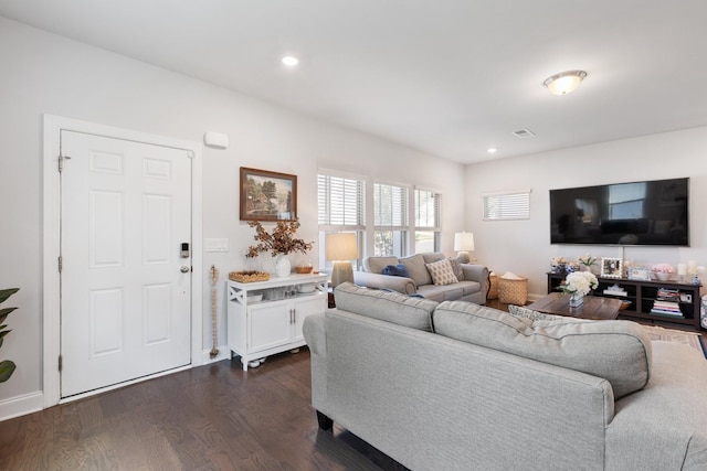 living room with recessed lighting, dark wood-style flooring, and visible vents