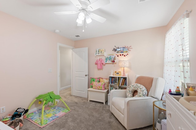 interior space featuring light carpet, visible vents, and a ceiling fan