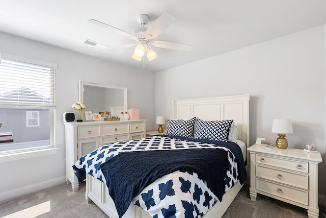 carpeted bedroom with baseboards, visible vents, and a ceiling fan