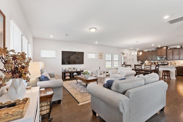 living area featuring visible vents, dark wood-type flooring, and recessed lighting