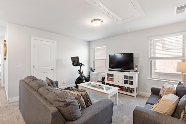 living area featuring attic access, visible vents, baseboards, and light colored carpet