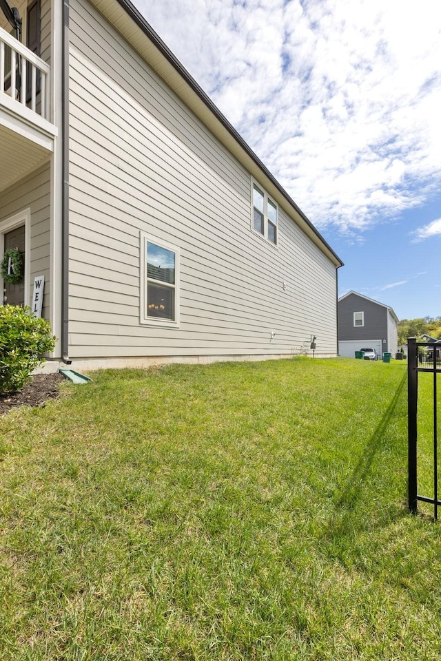 view of property exterior with a lawn and a balcony