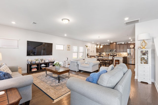 living room featuring dark wood-style floors, visible vents, a chandelier, and recessed lighting