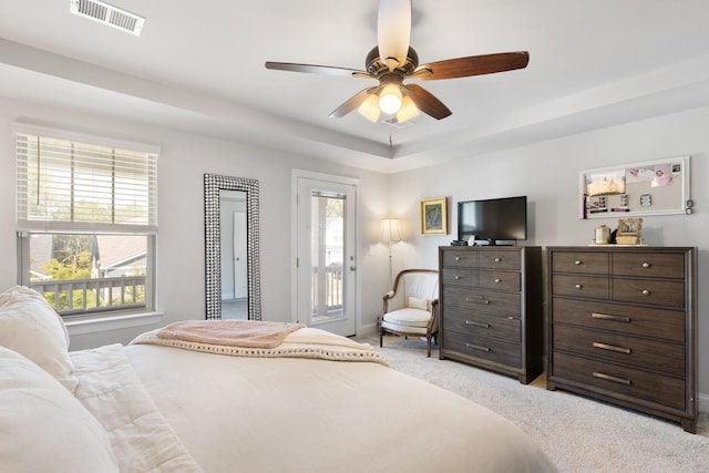 bedroom featuring access to exterior, visible vents, light carpet, and multiple windows