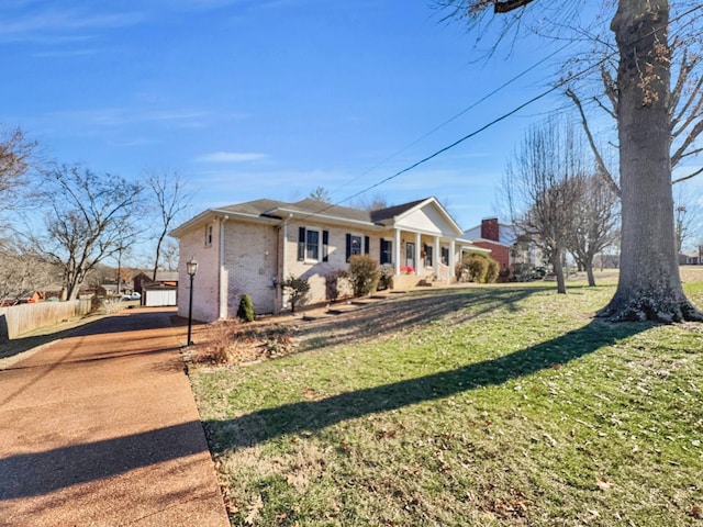 view of front of property featuring a front yard, covered porch, brick siding, and fence