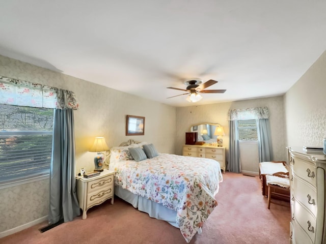 carpeted bedroom featuring wallpapered walls, a ceiling fan, and baseboards