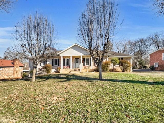 view of front of property featuring a porch, brick siding, and a front lawn