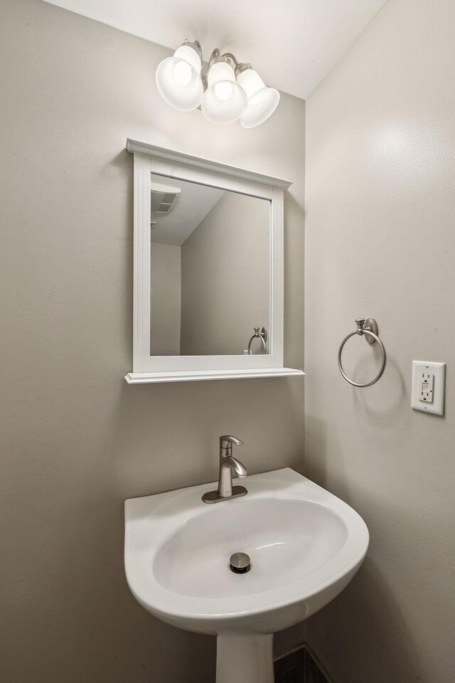 bathroom featuring visible vents and a sink